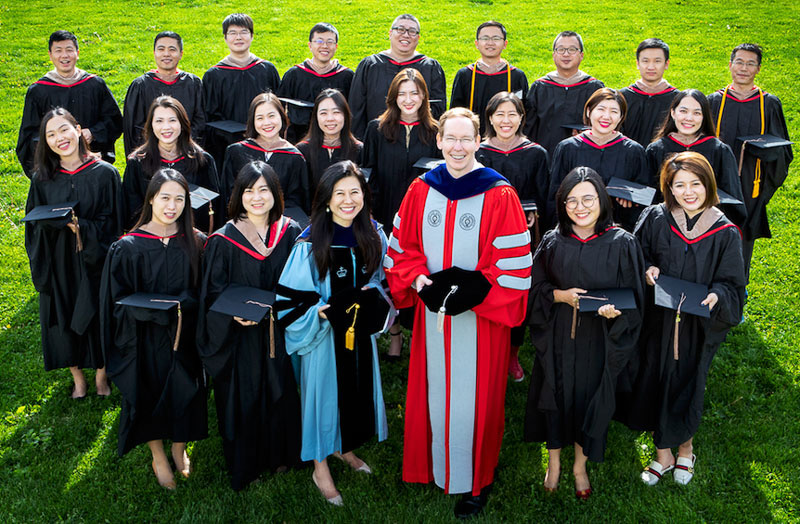 Photo of Cornell-Tsinghua graduates outside during Commencement in 2018