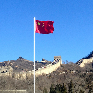 Chinese flag with Great Wall in background