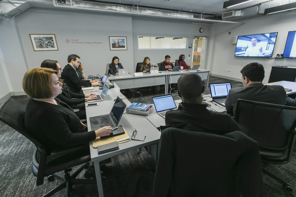 Students seated in an Americas boardroom