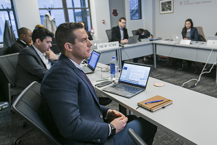 Students seated around a boardroom table