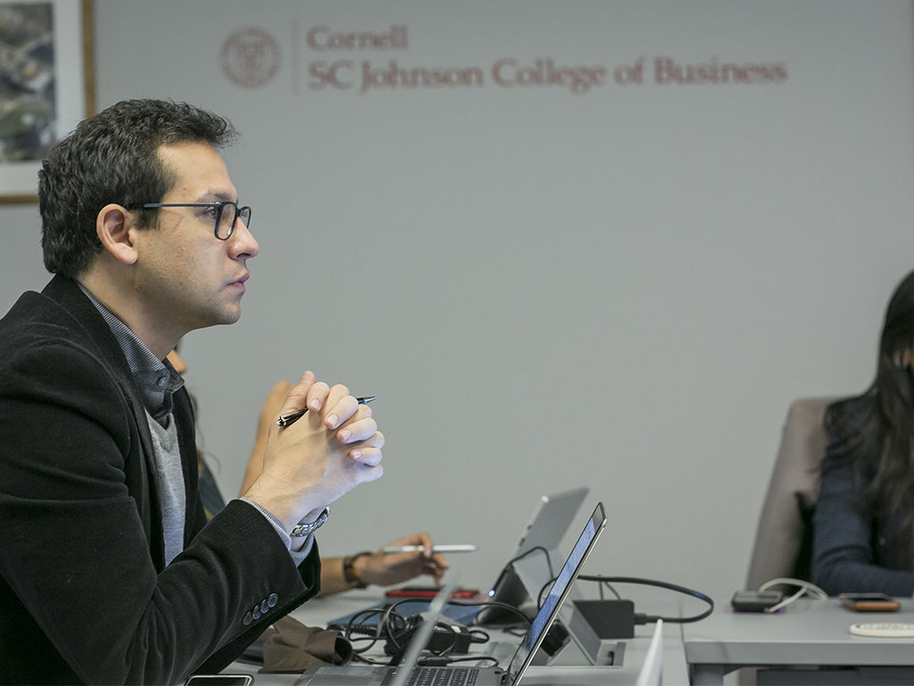 A male student looks at a television monitor