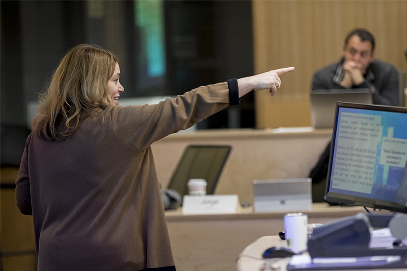 Risa Mish pointing out into the classroom