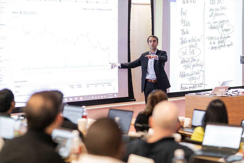 Professor standing at the front of the lecture hall at the tech campus