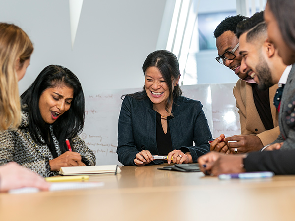 Students collaborate around a table