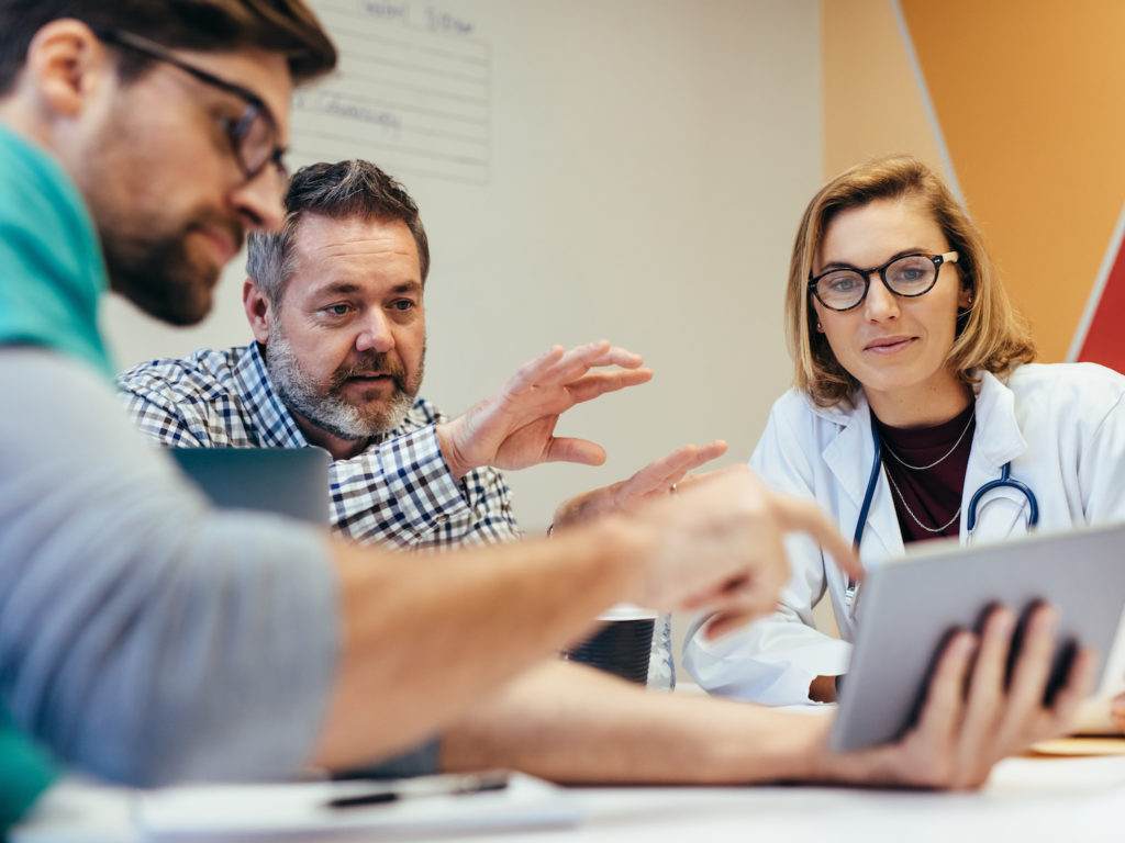 Medical and business staff in discussion