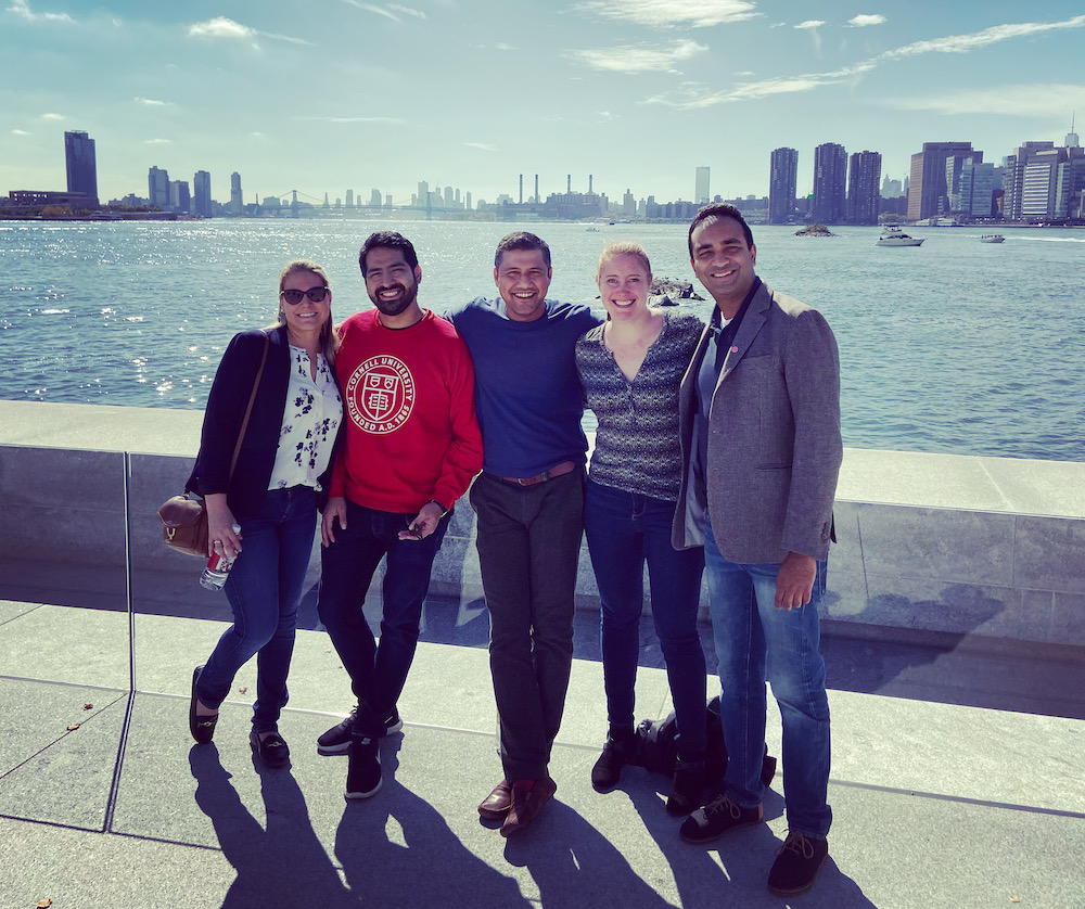 EMBA Metro NY students with the NYC skyline from Roosevelt Island