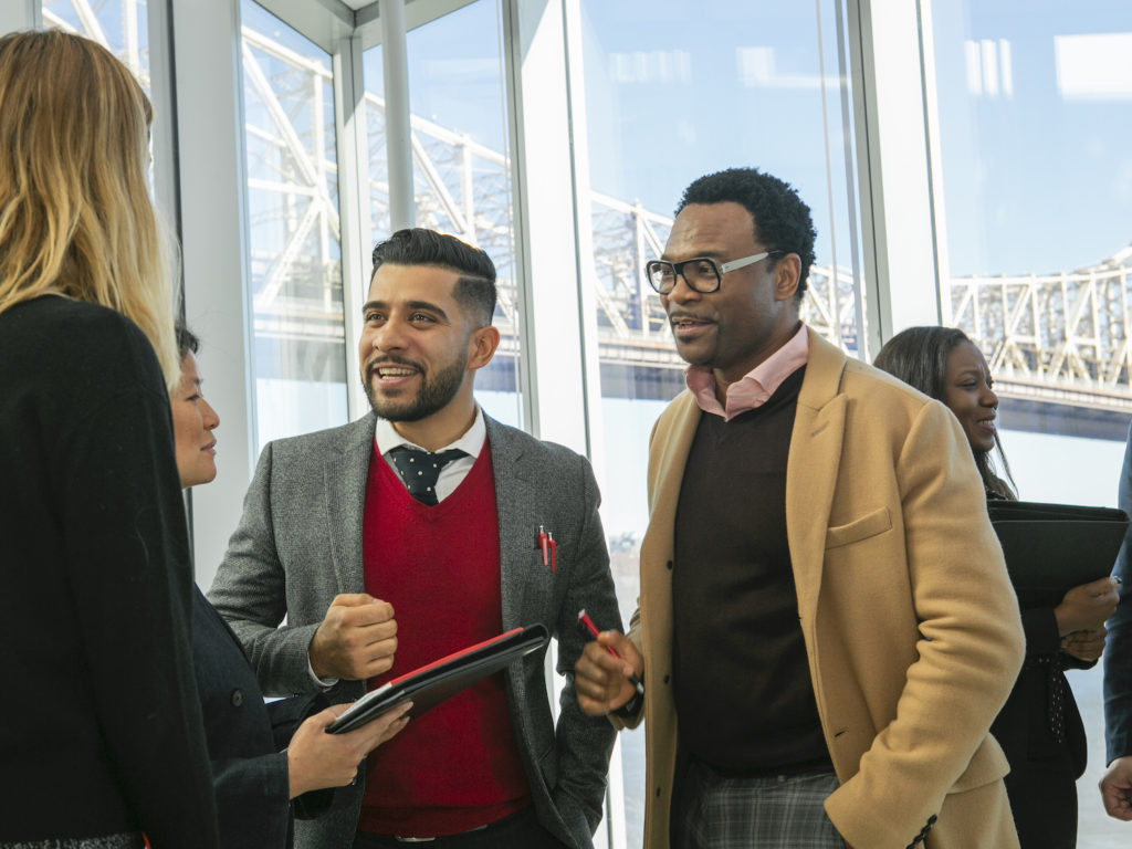 Students stand in a lobby together