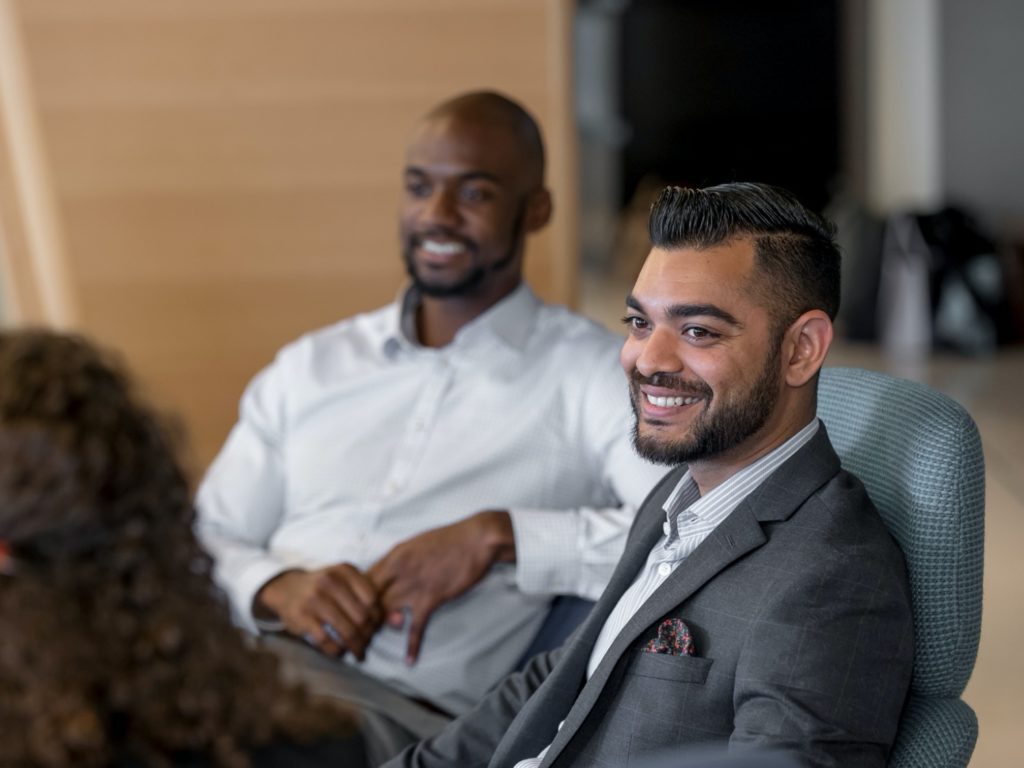 Two Johnson management students smiling.