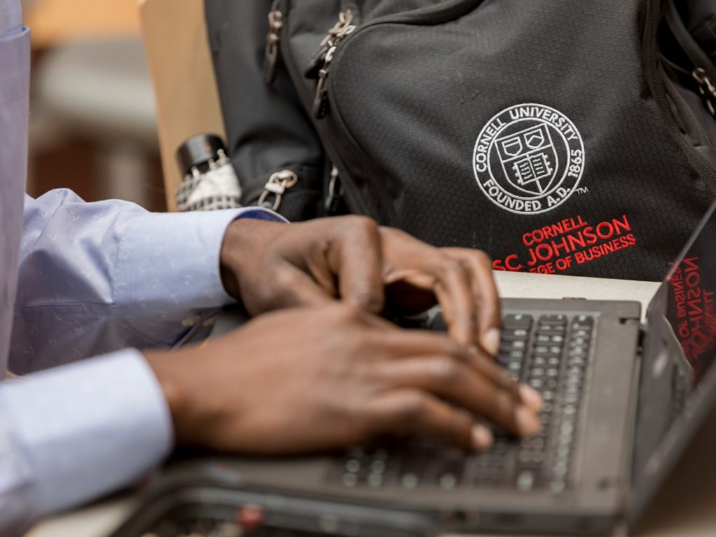 Student typing on a laptop.