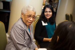 Two women talk and smile