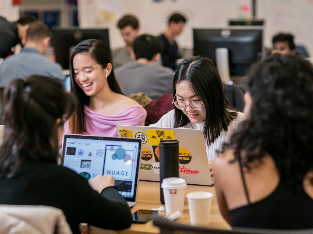 Students working in groups and using computers