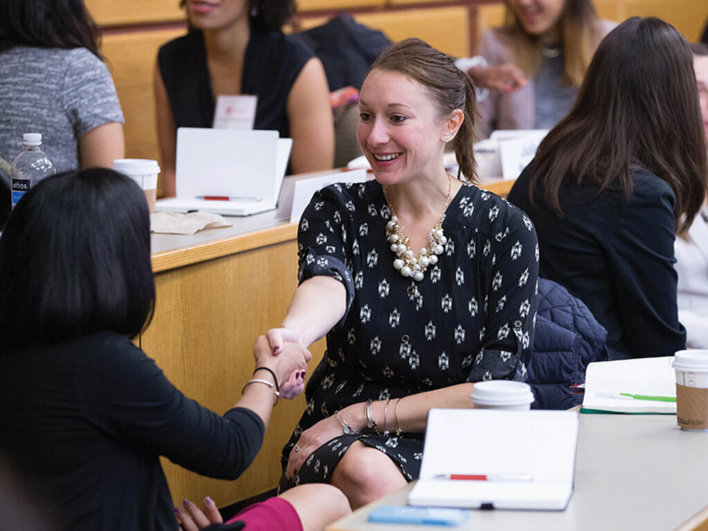 Two women shaking hands