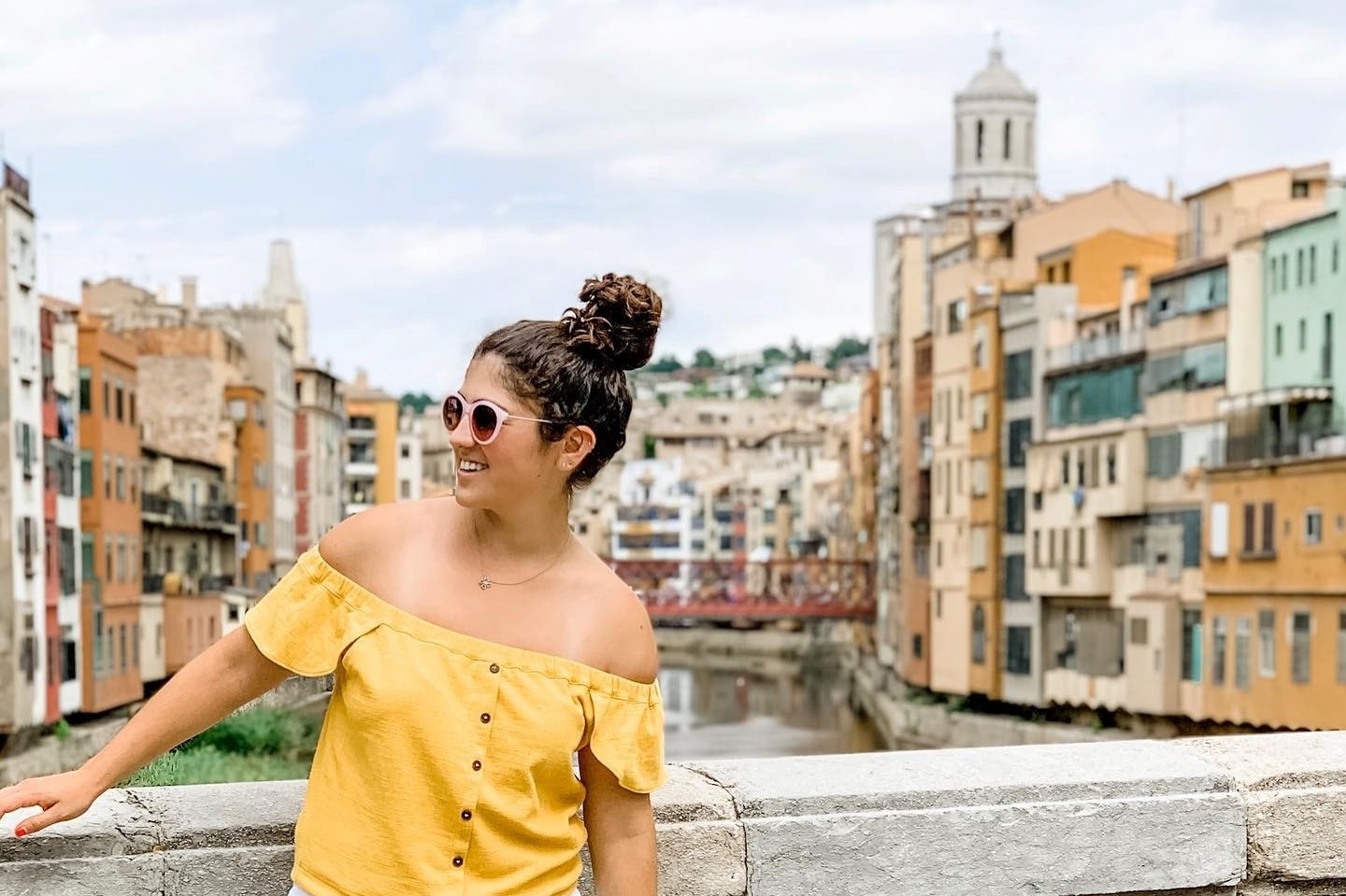 The author poses on a bridge while touring an European city.