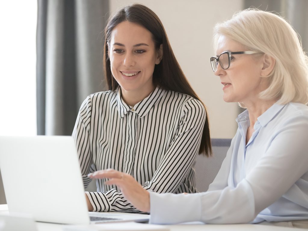 two people looking at laptop