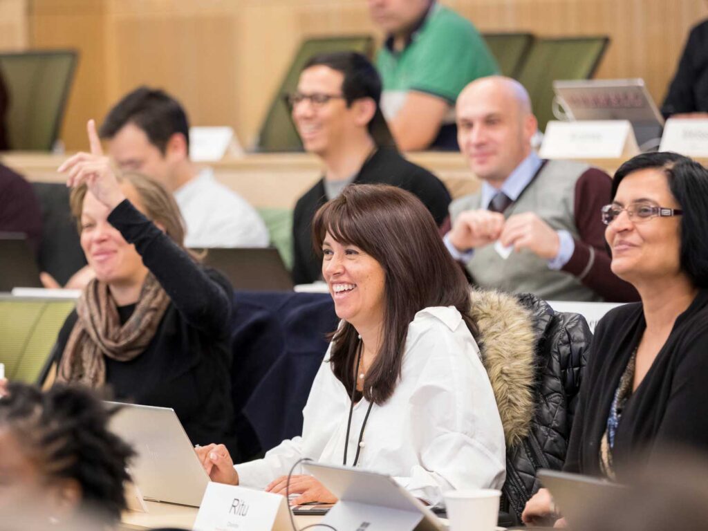 Individuals participating in a discussion in a tiered classroom