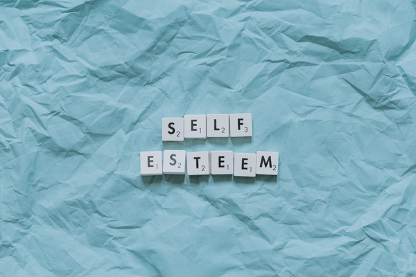 the words self esteem unwrapped in paper