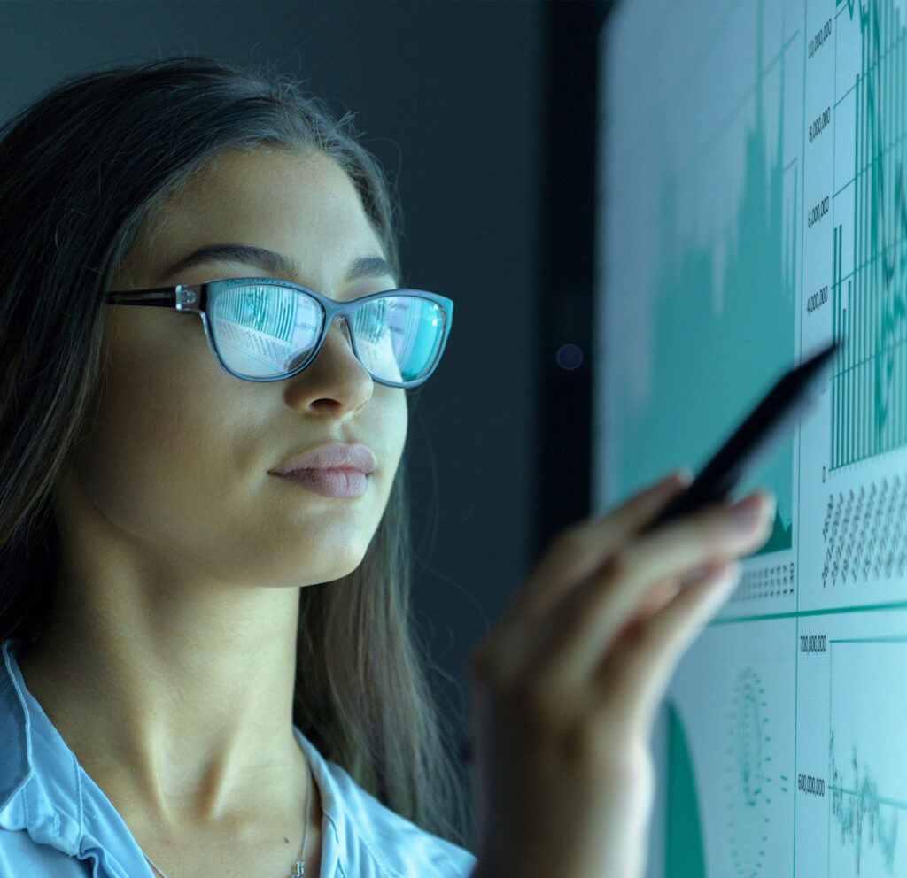 Student reviewing data on a large screen.
