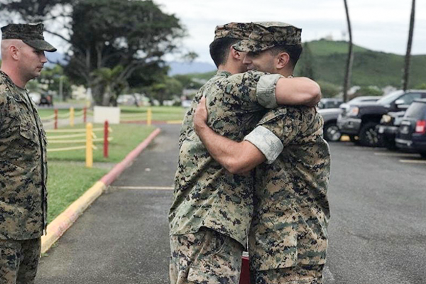 Edmund Fuentes in military uniform hugging another solider