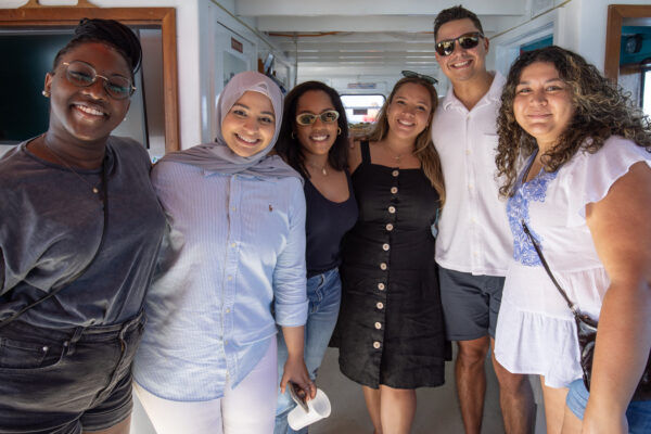 Group of MBA students posing on a boat.