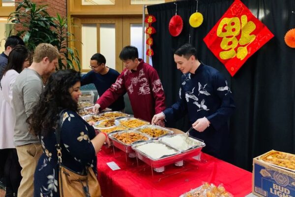 People being served Asian cuisine.