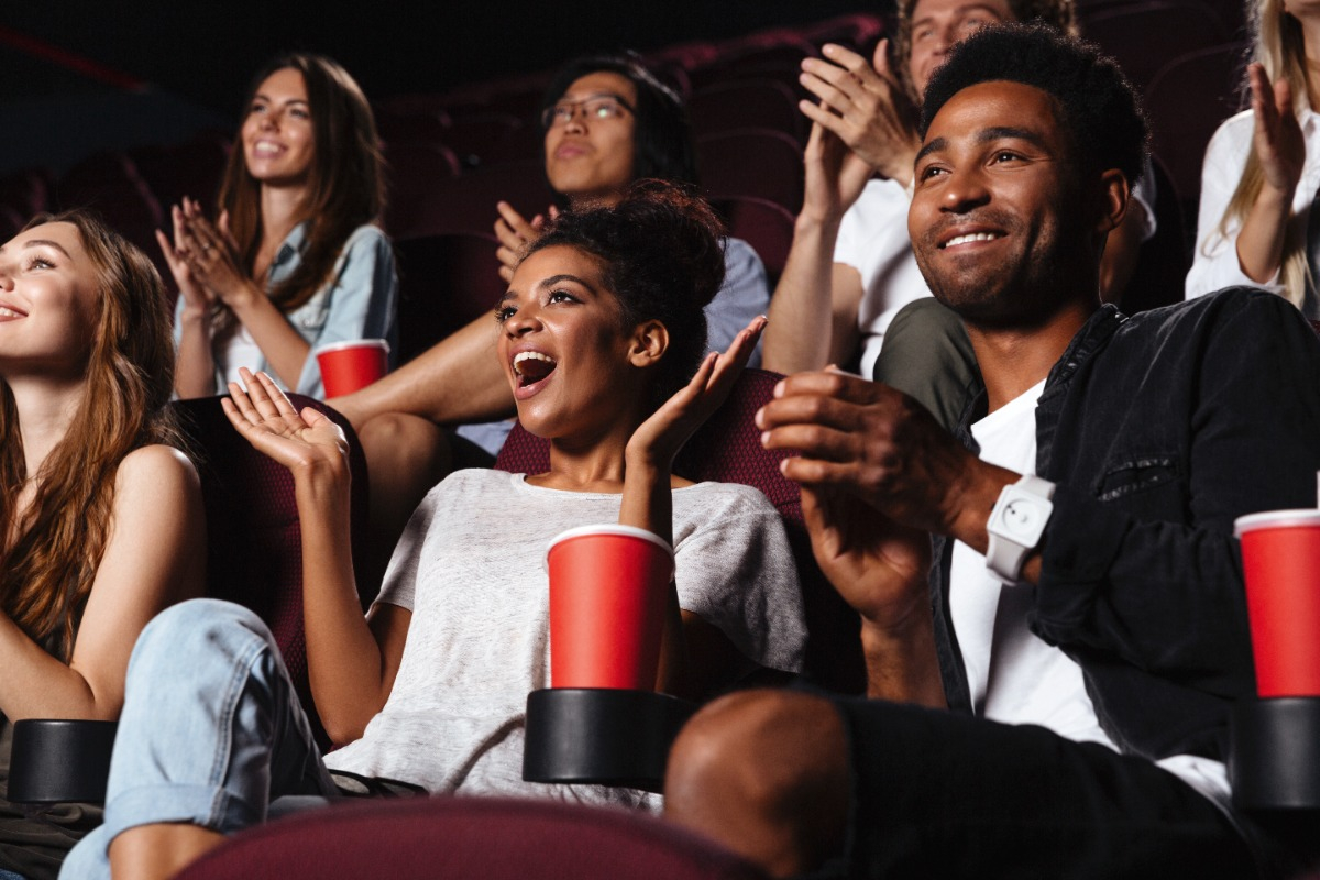 Audience sitting in bleachers and clapping.