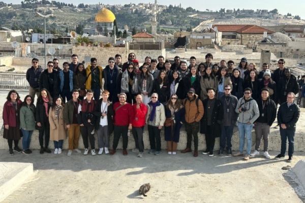 Students on the Israel trek pose for a photo with a view of Jerusalem in the background.