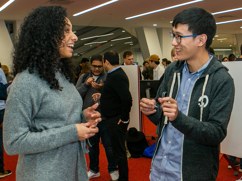 Two people chatting and smiling.