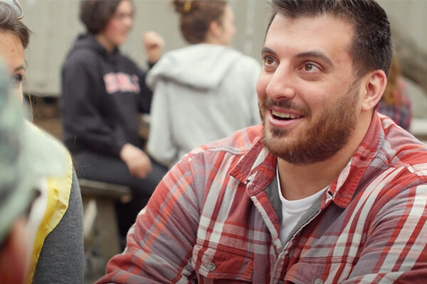 Full-time MBA students Nikolaos smiles at something out of frame.