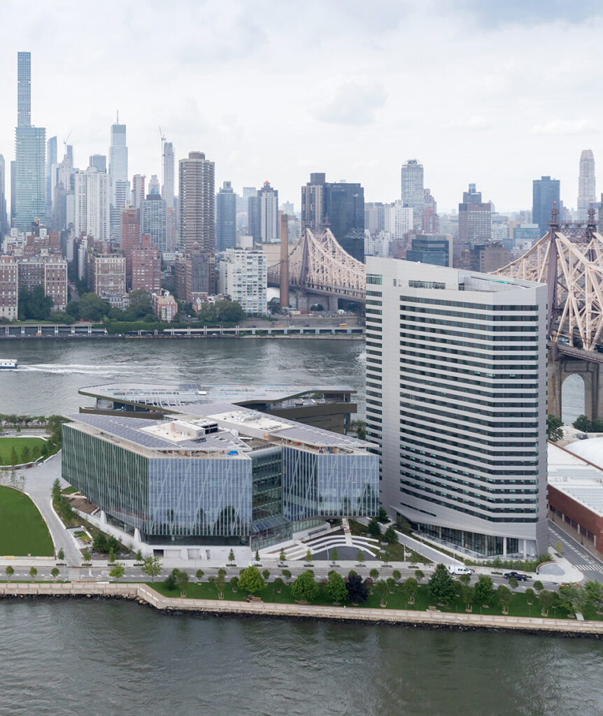 Aerial view of the Cornell Tech campus on Roosevelt Island with Manhattan in the background.