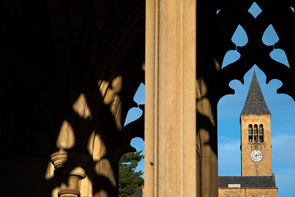 McGraw Tower clock tower viewed through a window.