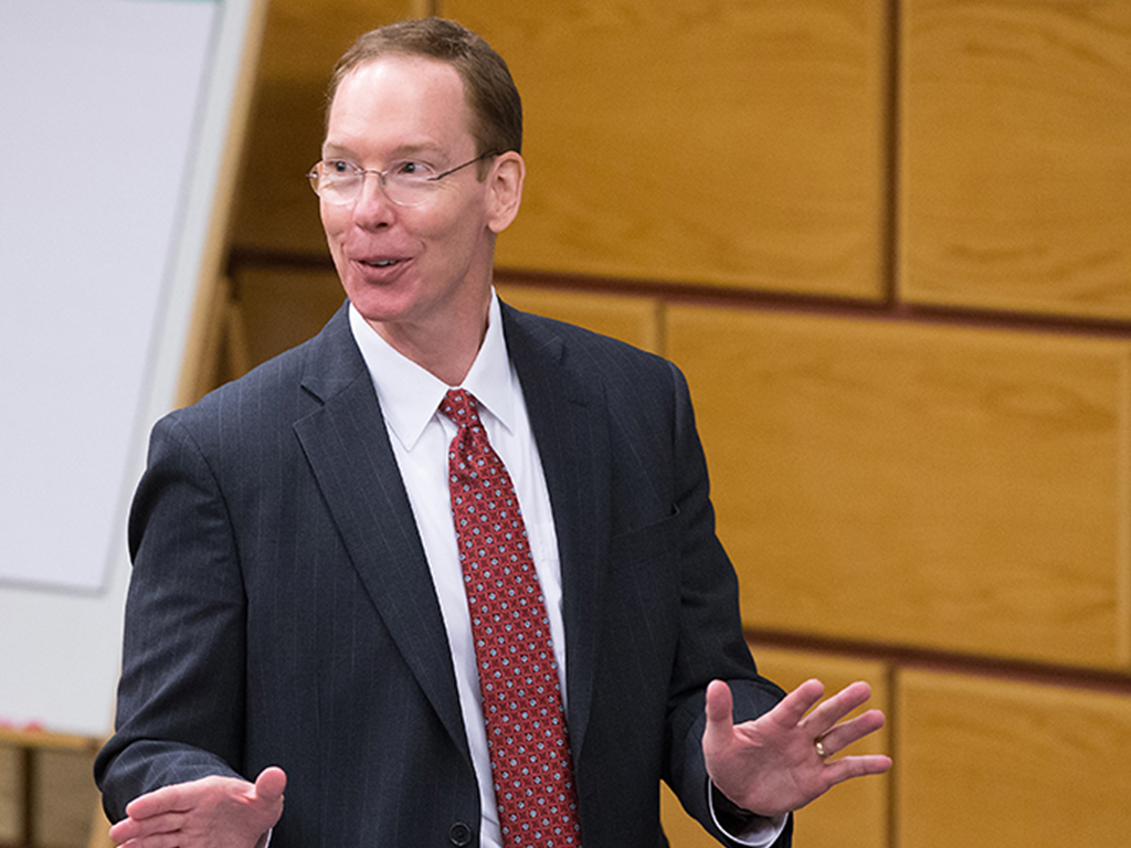 Professor Mark Nelson teaching in front of a classroom.