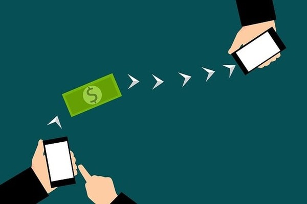 illustration of two mobile phones connected by arrows with a dollar bill between them.