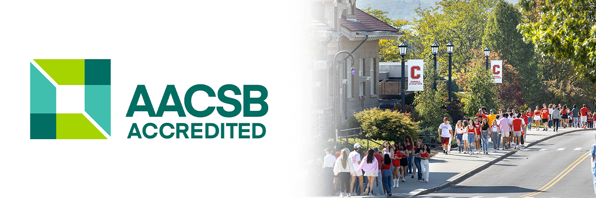 AACSB Accredited logo fading into a photo of people walking on a sidewalk with Cornell flags.