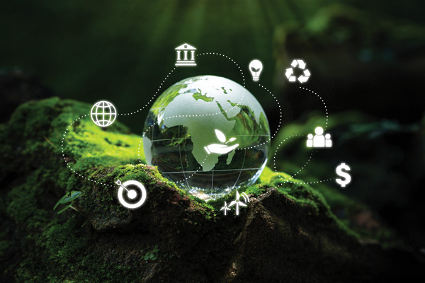 Photo of a crystal globe on a bed of moss overlaid with ESG icons for Environment, Social, and Governance, as well as world sustainable environment concepts/icons.