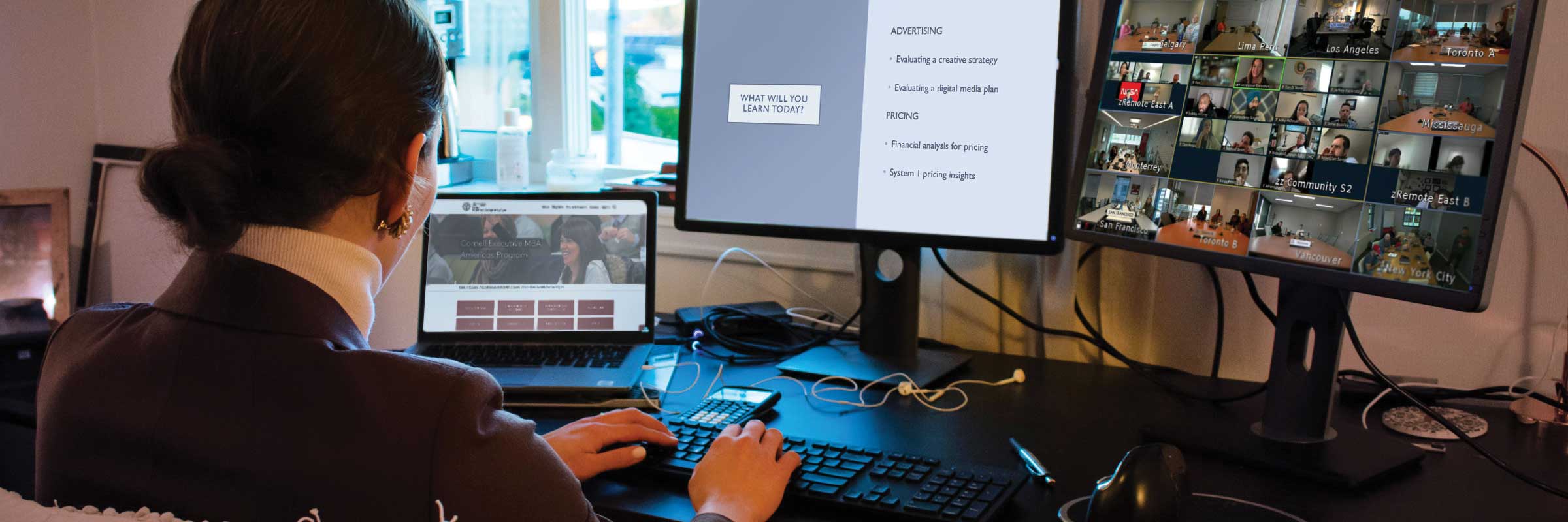 Person in front of two monitors and a laptop on a Zoom call.