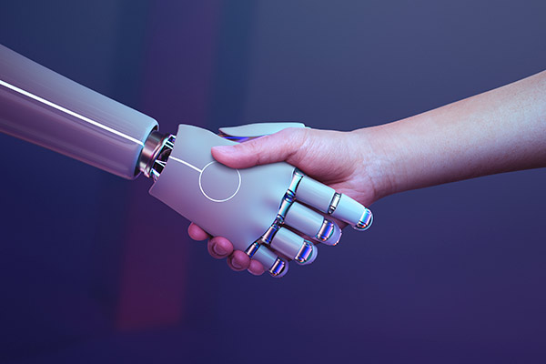 An image of a robot hand shaking the hand of a human.