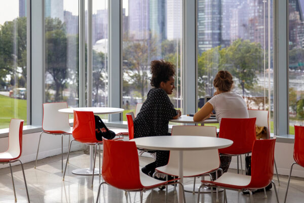 Two female students sitting at table at the Tata Innovation Center.