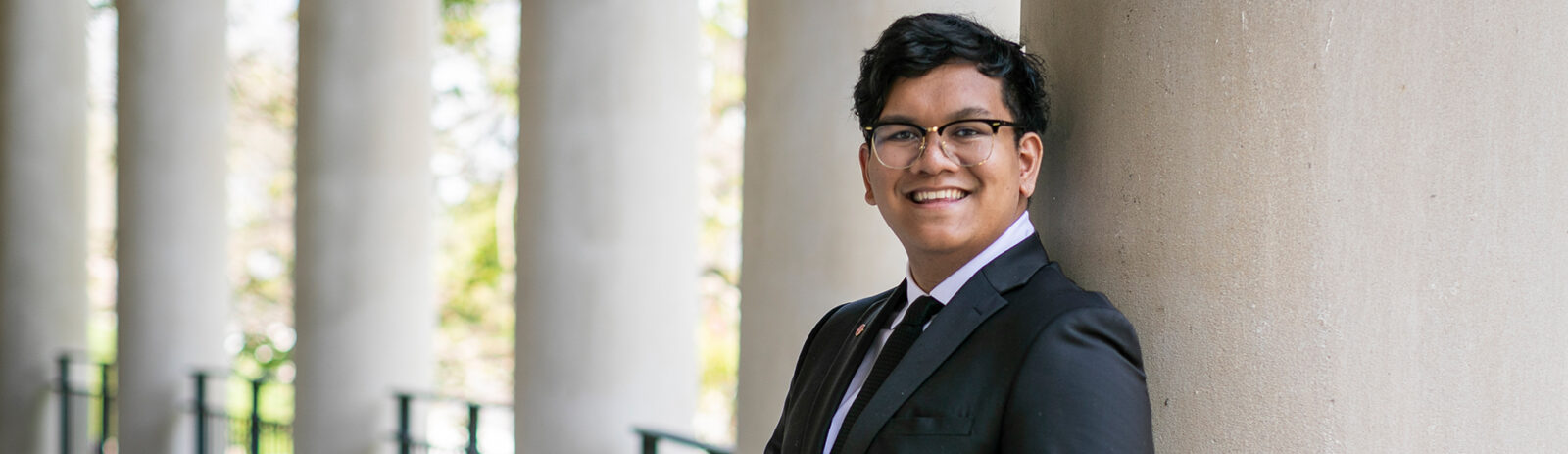 A male student smiling at the camera.