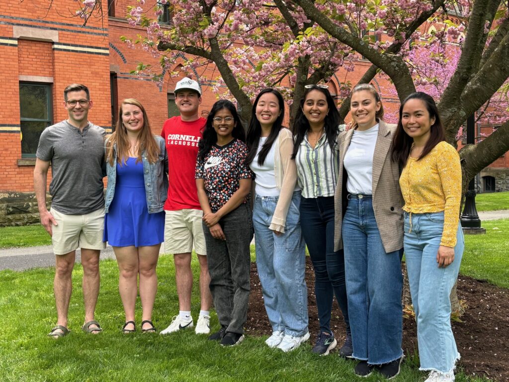 a group of students pose for a photo on a spring day