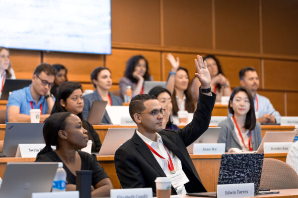 Students raising their hand in class.