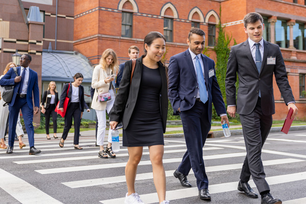 MBA Students walking across Feeney Way after leaving Sage Hall