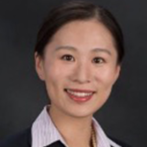 head and shoulders of a woman in business formal smiling at the camera