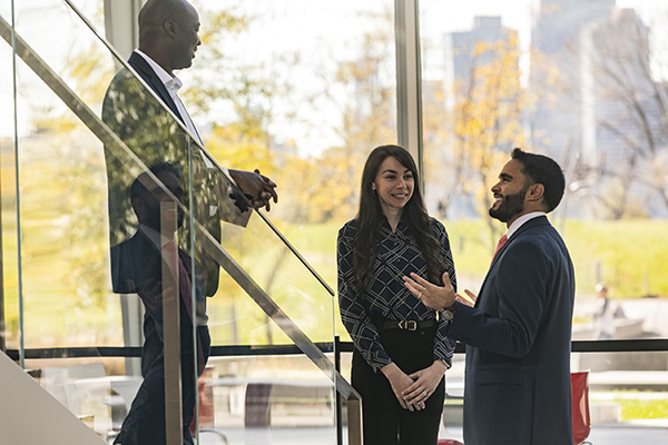 Three professionals speaking outside the classroom