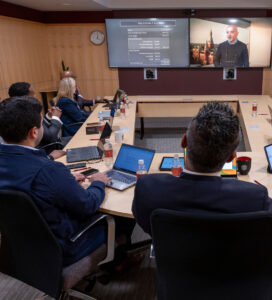 Students in class participating in boardroom