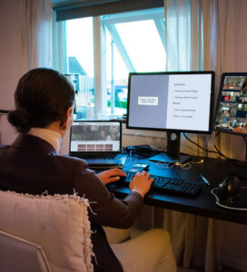 Female student at home participating in boardroom on her computer
