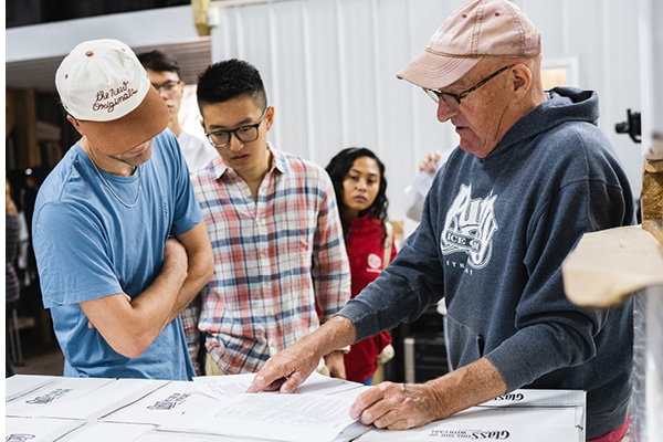 Pete Saltonstall, co-owner of Treleaven Wines, shows previous Dyson students documents.