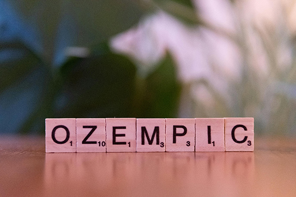 ozempic scrabble tiles on wooden surface